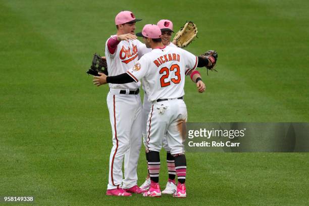 Trey Mancini , Craig Gentry, and Joey Rickard of the Baltimore Orioles celebrate following the Orioles 17-1 win over the Tampa Bay Rays at Oriole...