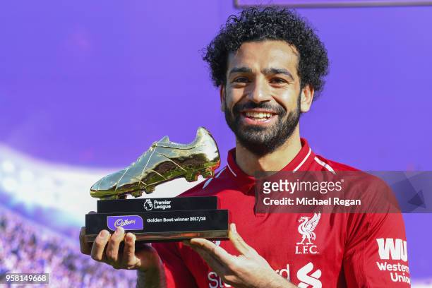 Mohamed Salah of Liverpool poses for a photo with his Premier League Golden Boot Award after the Premier League match between Liverpool and Brighton...