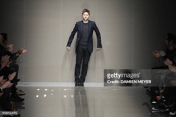 Designer Christopher Bailey salutes at the end of the Burberry Prorsum Fall-Winter 2010-2011 Menswear collection on January 16, 2010 during the Men's...