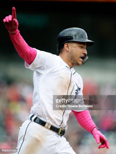 Jose Iglesias of the Detroit Tigers celebrates as he runs to first base after hitting a single in the ninth inning to drive in Jacoby Jones and beat...