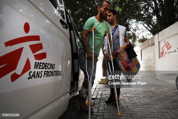Man who was shot in his leg during protests at the Gaza/Israel border fence enters a medical clinic operated by Medecins Sans Frontieres/Doctors...
