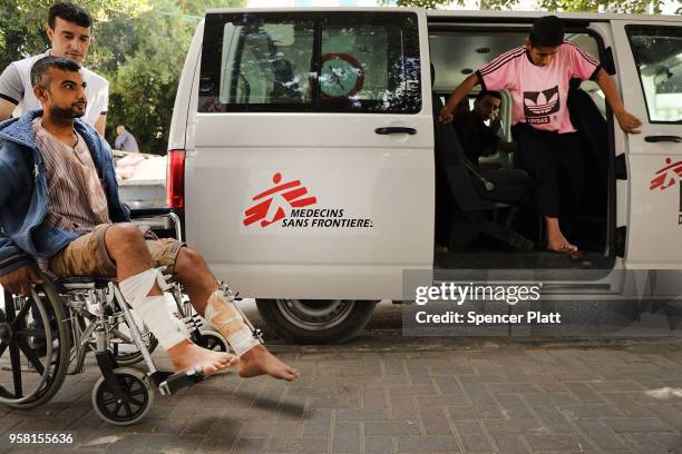 Man who was shot in his legs during protests at the Gaza/Israel border fence enters a medical clinic operated by Medecins Sans Frontieres/Doctors...