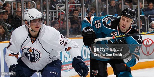 Denis Grebeshkov of the Edmonton Oilers skates with Ryane Clowe of the San Jose Sharks during an NHL game on January 16, 2010 at HP Pavilion at San...