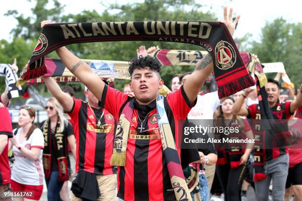 Atlanta United FC supporters march prior to a MLS soccer match against the Orlando City SC at Orlando City Stadium on May 13, 2018 in Orlando,...