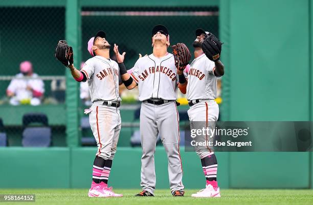 Gregor Blanco, Gorkys Hernandez and Andrew McCutchen of the San Francisco Giants celebrate after a 5-0 win over the Pittsburgh Pirates at PNC Park on...