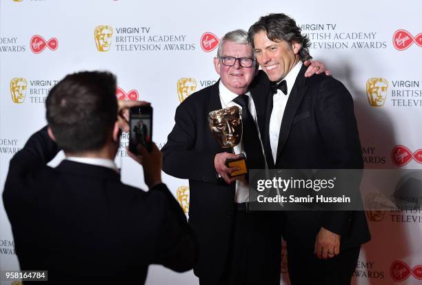 John Motson poses with his special award and John Bishop in the press room during the Virgin TV British Academy Television Awards at The Royal...