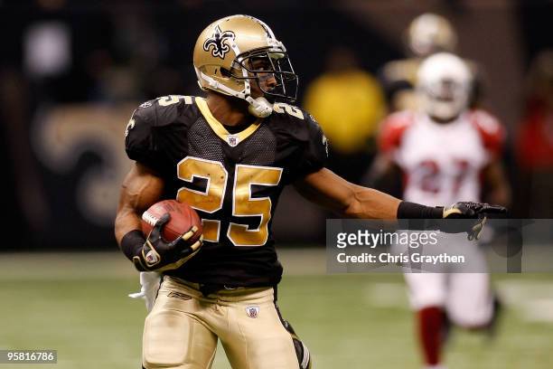 Reggie Bush of the New Orleans Saints gestures towards a defender as he scores on a 83-yard punt return for a touchdown in the third quarter against...