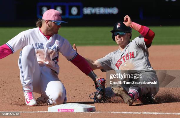 Brock Holt of the Boston Red Sox is caught stealing at third base in the ninth inning during MLB game action as Josh Donaldson of the Toronto Blue...