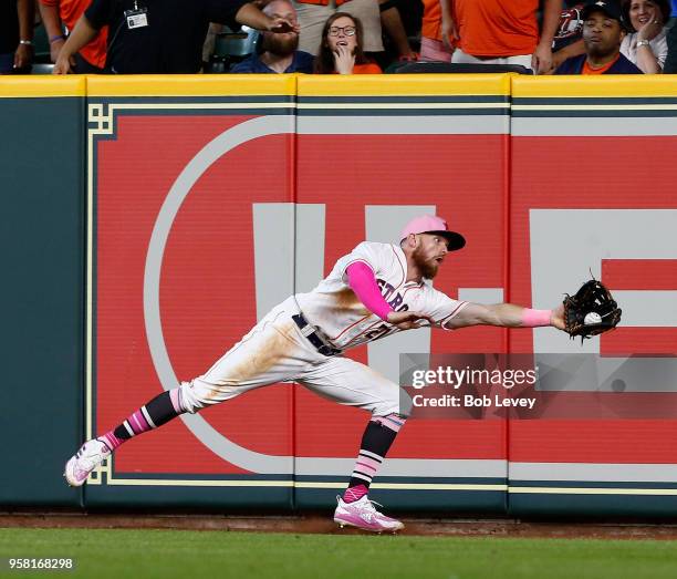 Derek Fisher of the Houston Astros makes a catch in the corner on a line drive by Ryan Rua of the Texas Rangers in the eighth inning at Minute Maid...