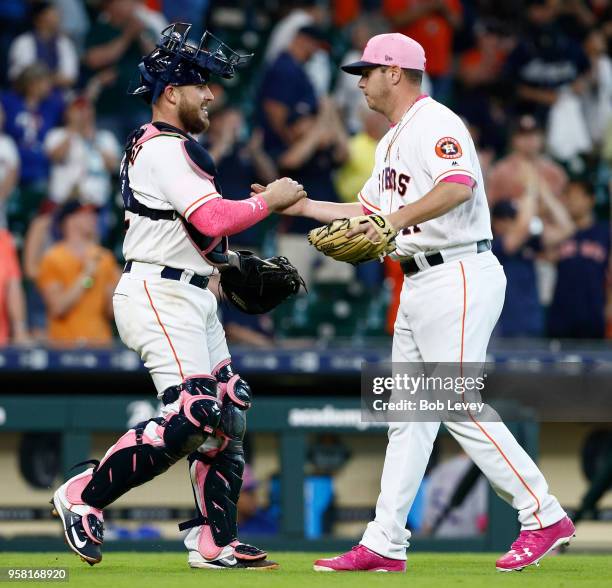 Brad Peacock of the Houston Astros shakes hands with catcher Max Stassi after the final out against the Texas Rangers at Minute Maid Park on May 13,...