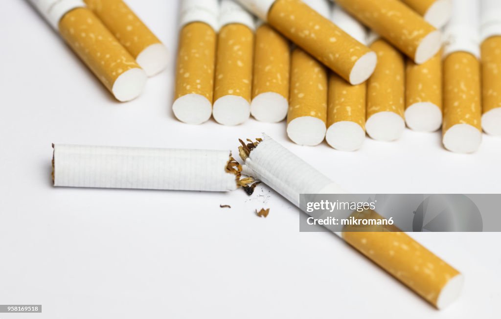Breaking the habit. Cigarettes on white background