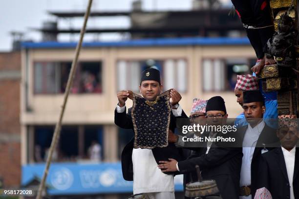 Members of Guthi Sansthan displaying the bejeweled vest known as Bhoto to the public from the chariot on celebration of Bhoto Jatra festival at...