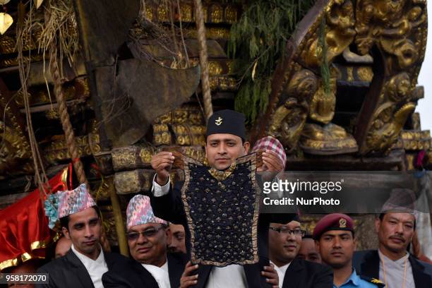 Members of Guthi Sansthan displaying the bejeweled vest known as Bhoto to the public from the chariot on celebration of Bhoto Jatra festival at...