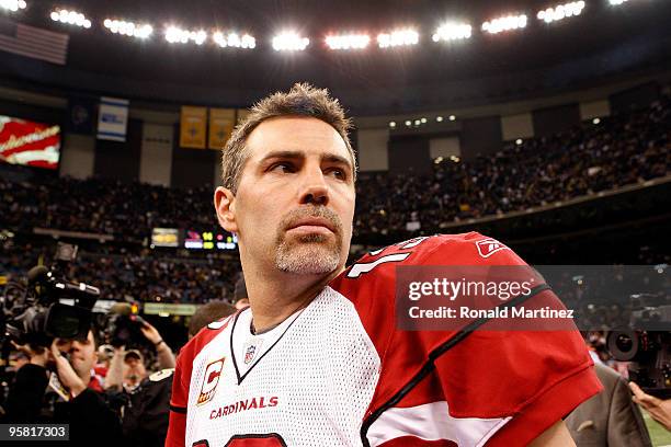 Quarterback Kurt Warner of the Arizona Cardinals looks on as he stands on the field after their 45-14 loss against the New Orleans Saints during the...