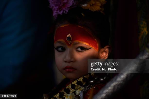 Yrs old Living goddess of Patan, Nihira Bajracharya, observing displaying the bejeweled vest known as Bhoto to the public from the chariot on...