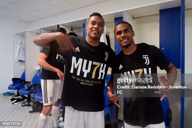 Alex Sandro and Douglas Costa of Juventus celebrate their seventh league titles in a row after the serie A match between AS Roma and Juventus at...