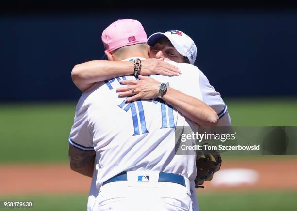 Kevin Pillar of the Toronto Blue Jays hugs his mother Wendy Pillar after she threw out the first pitch before the start of MLB game action against...