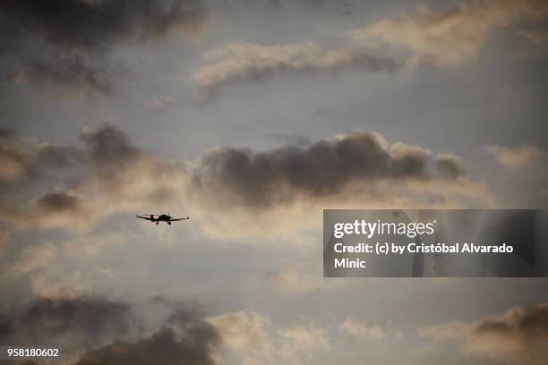 airplane with clouds background - alvarado minic stock pictures, royalty-free photos & images