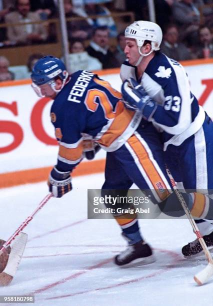 Bernie Federko of the St. Louis Blues skates against Al Iafrate of the Toronto Maple Leafs during NHL game action on March 9, 1989 at Maple Leaf...