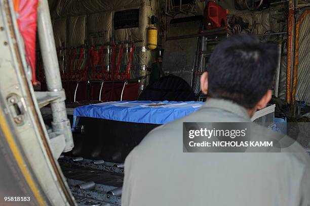 Member of the Argentinian armed forces looks at the casket of one of his colleagues killed in the colapse of the Minustah headquarters at...