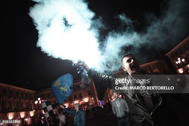 Juventus' supporters celebrate in central Turin after their team won a seventh straight Serie A title "scudetto" after a goalless draw against...