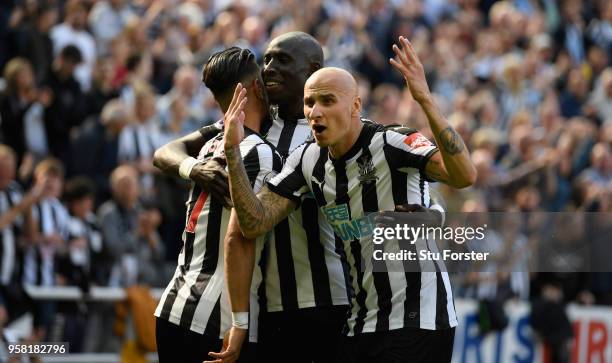 Newcastle player Jonjo Shelvey celebrates with goalscorer Ayoze Perez and Mo Diame after the second goal during the Premier League match between...