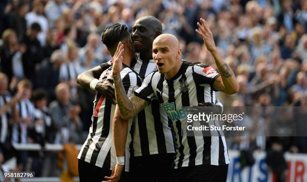 Newcastle player Jonjo Shelvey celebrates with goalscorer Ayoze Perez and Mo Diame after the second goal during the Premier League match between...