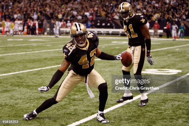 Darren Sharper and Roman Harper of the New Orleans Saints celebrate after Sharper broke up a pass play against the Arizona Cardinals during the NFC...