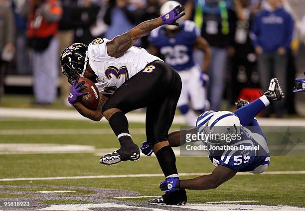Willis McGahee of the Baltimore Ravens runs the ball as Clint Session of the Indianapolis Colts dives after McGahee for the tackle in the third...