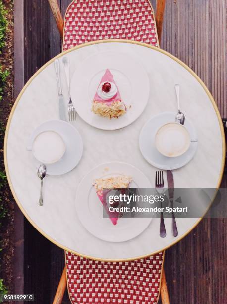 directly above view of table in cafe with two pieces of cake and coffee - cake table photos et images de collection