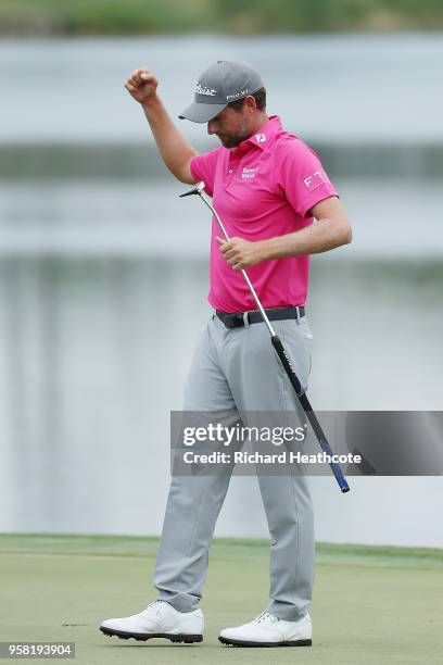 Webb Simpson of the United States celebrates on the 18th green after winning during the final round of THE PLAYERS Championship on the Stadium Course...