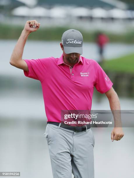 Webb Simpson of the United States celebrates on the 18th green after winning during the final round of THE PLAYERS Championship on the Stadium Course...