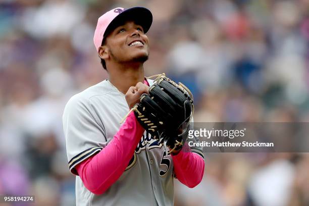 Starting pitcher Freddy Peralta of the Milwaukee Brewers walks to the dugout after being relieved in the sixth inning against the Colorado Rockies at...
