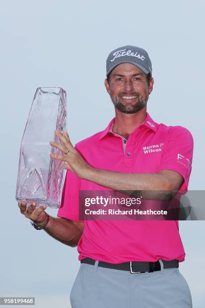 Webb Simpson of the United States celebrates with the winner's trophy after the final round of THE PLAYERS Championship on the Stadium Course at TPC...