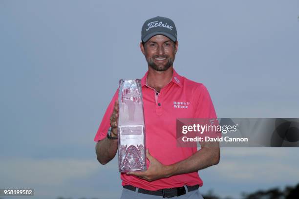 Webb Simpson of the United States holds the trophy after his four stroke victory the final round of the THE PLAYERS Championship on the Stadium...