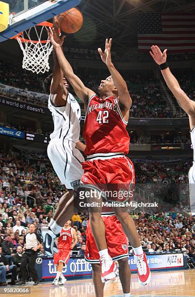 Charlie Bell of the Milwaukee Bucks gets his shot blocked by Ronnie Price of the Utah Jazz at EnergySolutions Arena on January 16, 2010 in Salt Lake...