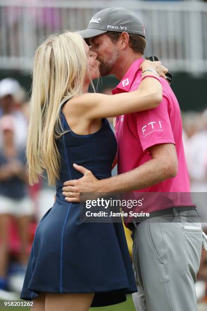 Webb Simpson of the United States celebrates with his wife Taylor Dowd on the 18th green after winning during the final round of THE PLAYERS...