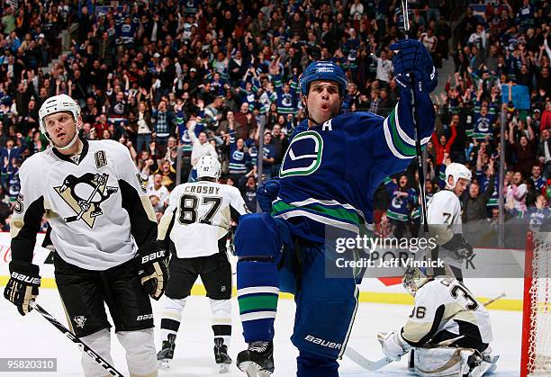 Willie Mitchell of the Vancouver Canucks celebrates his goal in front of Sergei Gonchar, Sidney Crosby, Mark Eaton and John Curry of the Pittsburgh...