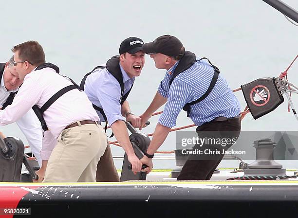 Prince William and his private secretary Jamie Lowther-Pinkerton winch in the sail on a 79 foot ex-America's Cup Yacht in Auckland Harbour on the...