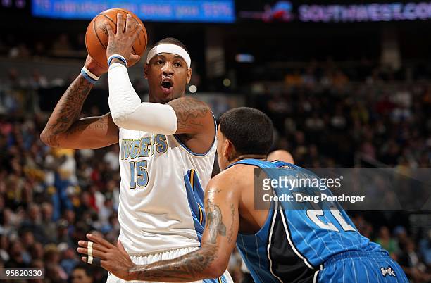 Carmelo Anthony of the Denver Nuggets controls the ball against Matt Barnes of the Orlando Magic during NBA action at Pepsi Center on January 13,...