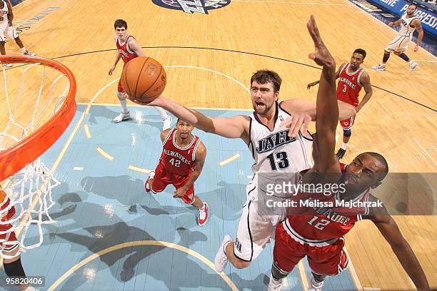 Mehmet Okur of the Utah Jazz goes up for the shot against Luc Mbah a Moute of the Milwaukee Bucks at EnergySolutions Arena on January 16, 2010 in...
