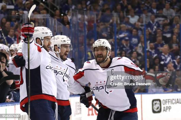 Tom Wilson of the Washington Capitals celebrates with Matt Niskanen and Alex Ovechkin after scoring a goal against Andrei Vasilevskiy of the Tampa...