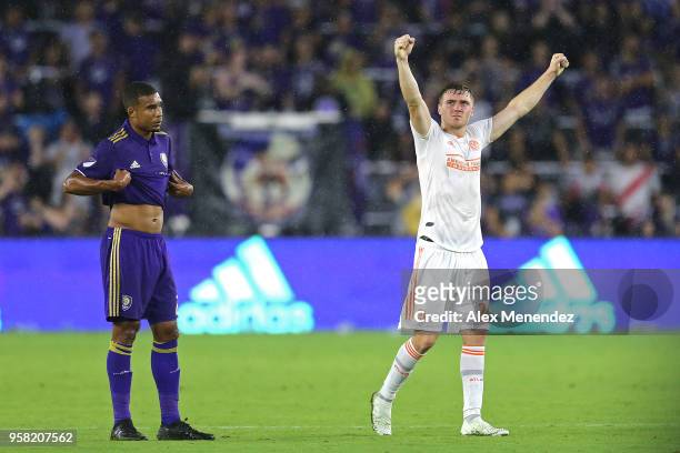 Julian Gressel of Atlanta United FC celebrates the 2-1 victory as Mohamed El-Munir of Orlando City SC looks on after a MLS soccer match between...