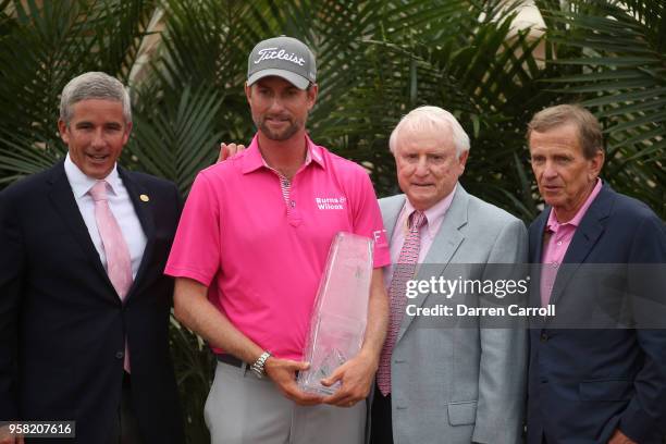 Webb Simpson holds the trophy with PGA TOUR commissioner Jay Monahan and Former PGA TOUR Commissioners Deane Beman and Tim Finchem during the final...