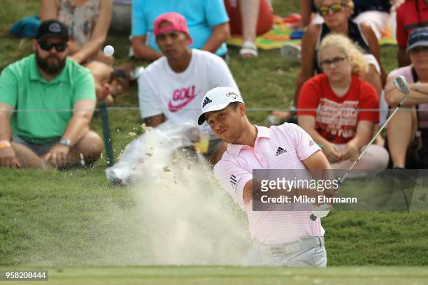 Xander Schauffele of the United States plays a shot from a bunker on the ninth hole during the final round of THE PLAYERS Championship on the Stadium...