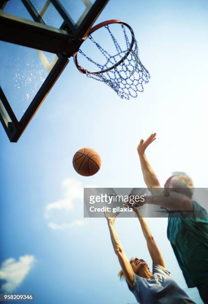 seniors playing basketball. - old basketball hoop stock pictures, royalty-free photos & images