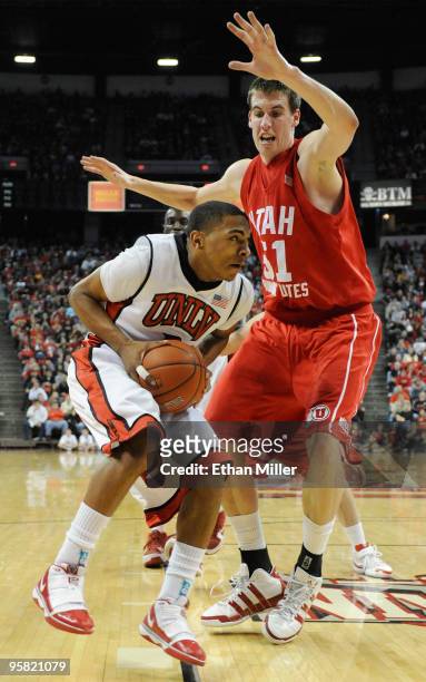 Anthony Marshall of the UNLV Rebels drives against David Foster of the Utah Utes during their game at the Thomas & Mack Center January 16, 2010 in...