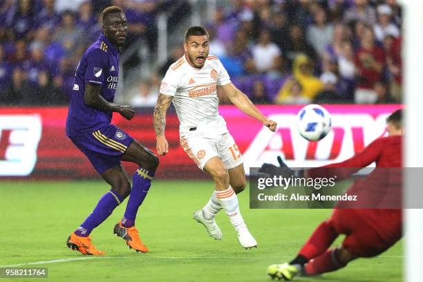 Hector Villalba of Atlanta United FC attempts a shot on goal past Lamine Sane of Orlando City SC and Joseph Bendik of Orlando City SC during a MLS...