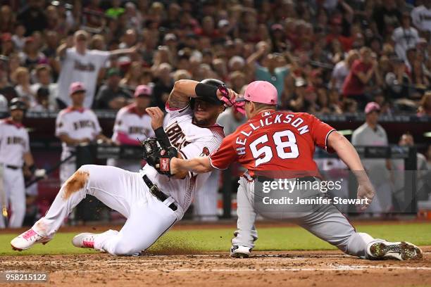 Jeremy Hellickson of the Washington Nationals tags out David Peralta of the Arizona Diamondbacks at home plate in the third inning of the MLB game at...