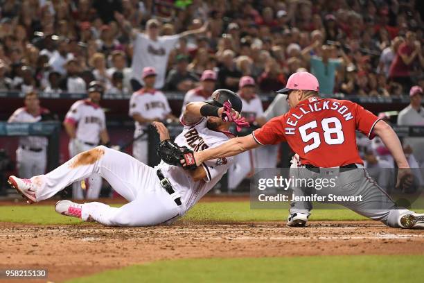 Jeremy Hellickson of the Washington Nationals tags out David Peralta of the Arizona Diamondbacks at home plate in the third inning of the MLB game at...